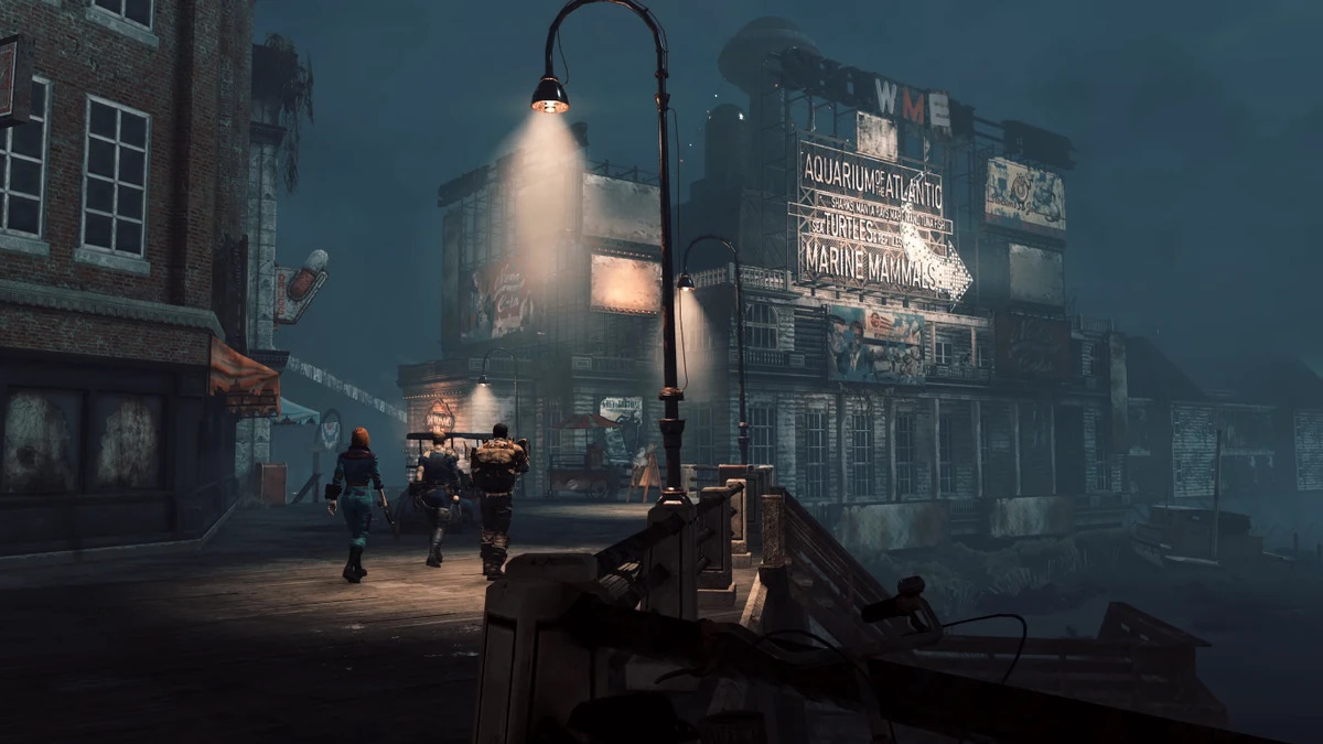 Group of Three Survivors Walking Along a Foggy Deserted Waterfront Street Toward a Dilapidated Building with Neon Signs and a Lit Lamppost