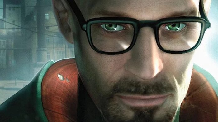 Close-up portrait of a man with black glasses and green eyes, looking at the camera, urban background behind him.