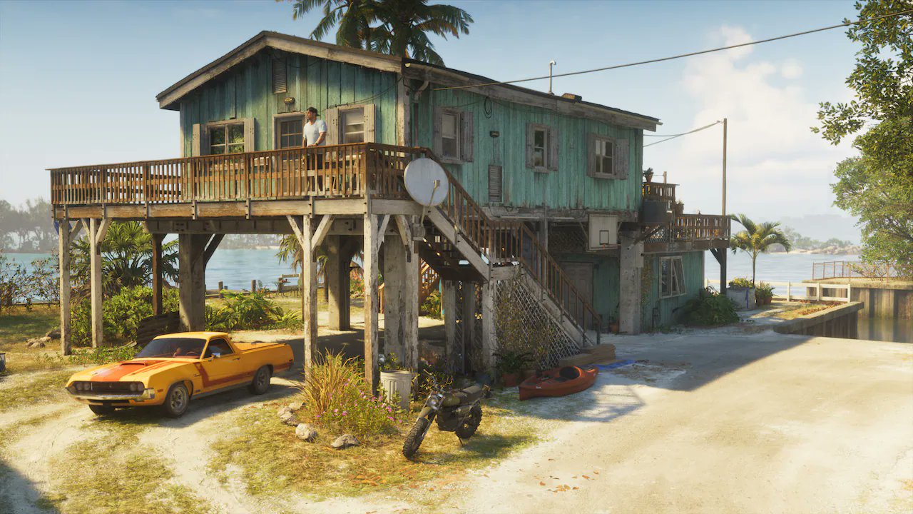 Hlkh0uix0aahtry Stilted Turquoise Beachfront House with a Wraparound Wooden Balcony a Yellow Vintage Car and a Motorcycle in the Yard by the Water