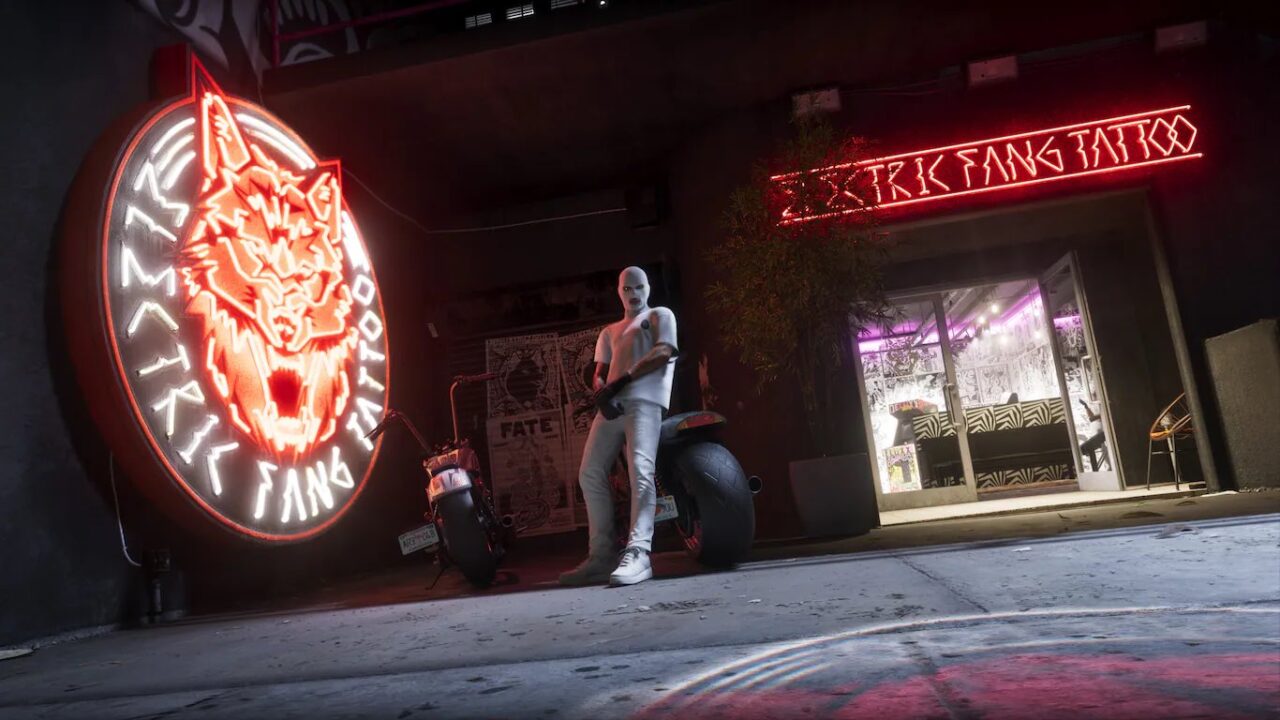 Person in White Attire Leaning on a White Motorcycle Outside a Storefront with Red Neon Signs and a Large Tiger Logo Circle