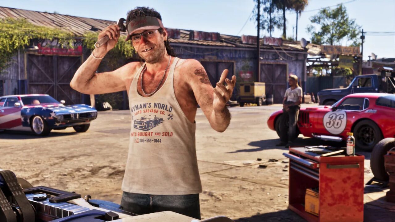 Man in a Dusty Tank Top and Visor in an Auto Salvage Yard Gesturing Toward the Camera with Old Cars and Tools Around
