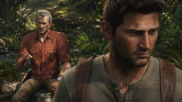 Close-up of a rugged man in a brown shirt with a backpack strap in a jungle; behind him, an older man in a red shirt points while seated with a rifle nearby.