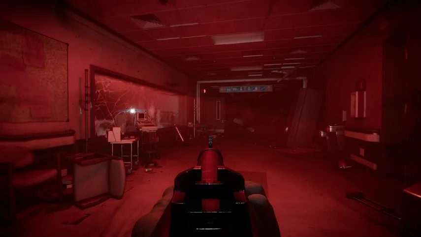 First person View of a Gun Aimed Down a Red lit Abandoned Hospital Corridor with Scattered Debris and Broken Equipment