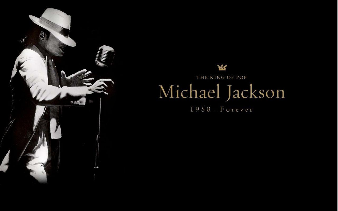 Wp2565542 Michael Jackson Performing on Stage in a White Suit and Hat Beside a Vintage Microphone Against a Black Background