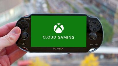 Handheld PS Vita being held, displaying a green screen with the Xbox Cloud Gaming logo in white.