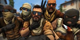 Five masked men with sunglasses pose for a close-up selfie; one shows a peace sign while a chicken wearing a party hat sits nearby.