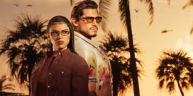 Two stylish adults stand back-to-back at sunset with palm trees in the background, wearing sunglasses and fashionable outfits.
